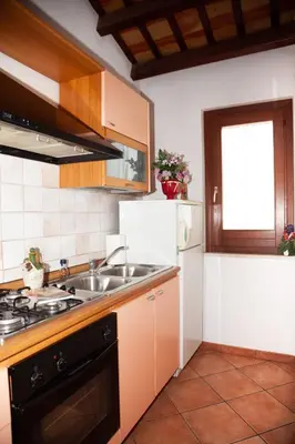 a kitchen with a sink and a refrigerator at Case Vacanza Sabbia Rosa in San Vito lo Capo