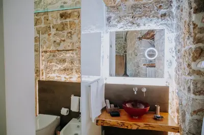 a bathroom with a sink and a mirror at Ambrosia-Timeless Hosting in Palermo