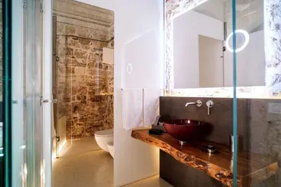 a bathroom with a sink and a mirror at Ambrosia-Timeless Hosting in Palermo