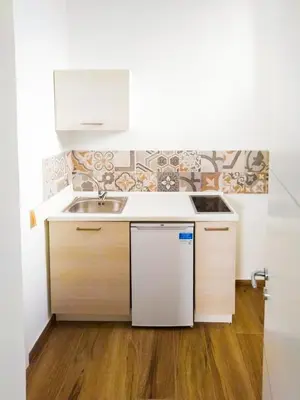 a small kitchen with a sink and a counter at IGIEA ROOMS in Palermo
