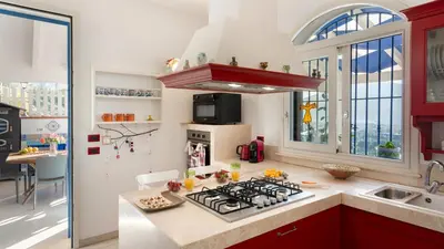 a kitchen with a stove top oven next to a sink at VILLA OLIMPIA 6&2, Emma Villas in Castellammare del Golfo