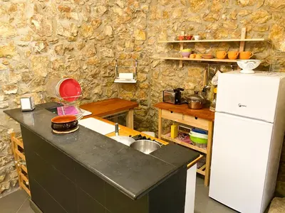 a kitchen with a sink and a refrigerator at Scopello Home in Castellammare del Golfo
