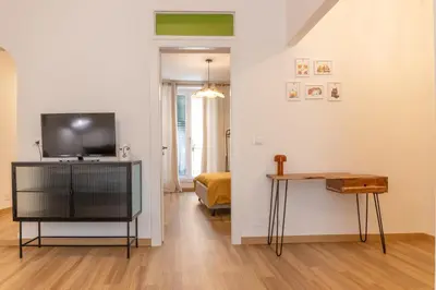 a living room with a television and a table at NicolHouse - Appartamento nel centro storico di Palermo in Palermo