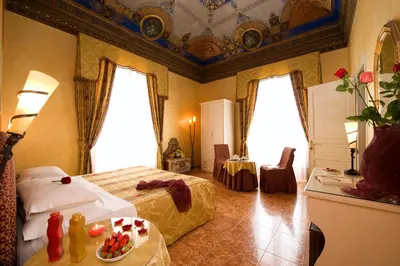 a bedroom with a bed and a table with a plate of food at Hotel Joli in Palermo
