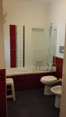 a bathroom with a toilet and a tub and a sink at Villetta Isola in Isola delle Femmine
