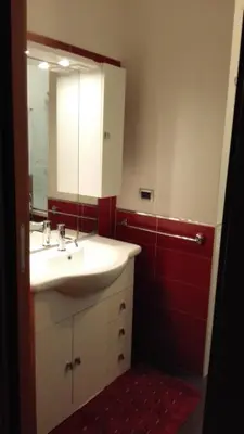 a bathroom with a sink and a mirror at Villetta Isola in Isola delle Femmine