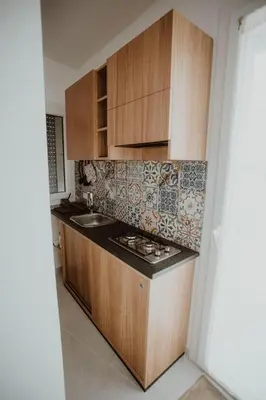 a kitchen with wooden cabinets and a stove top oven at Casa Vacanze Galati in Palermo