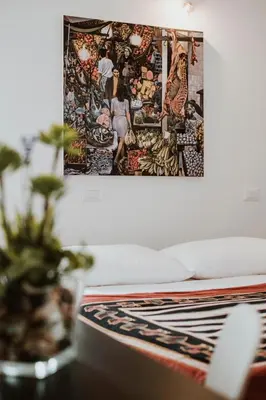 a room with a bed and a picture on the wall at Casa Vacanze Galati in Palermo