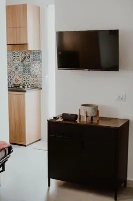 a kitchen with a desk with a television on the wall at Casa Vacanze Galati in Palermo