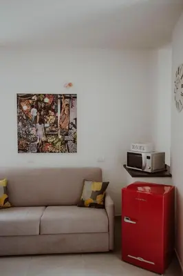 a living room with a couch and a microwave at Casa Vacanze Galati in Palermo
