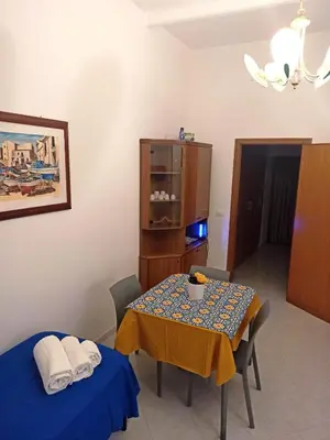 a dining room with a table and a table and chairs at CASETTA PONENTE in Isola delle Femmine