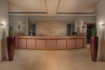a lobby with a reception desk in a building at NH Palermo in Palermo