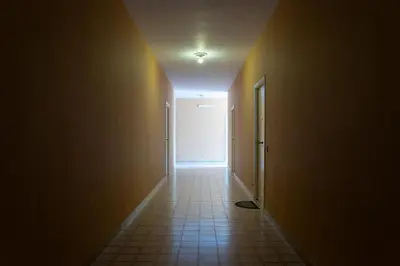 an empty hallway with a door and a tile floor at Appartamento Ashur Mondello in Palermo