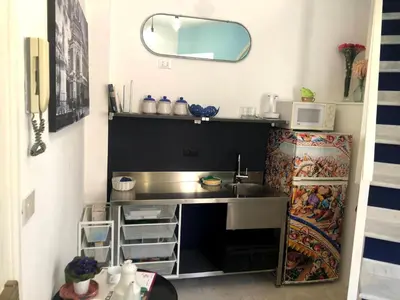 a small kitchen with a sink and a microwave at APPALERMO la tua casa ideale per visitare la città in Palermo