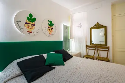 a bedroom with a bed with four plates on the wall at APPALERMO la tua casa ideale per visitare la città in Palermo