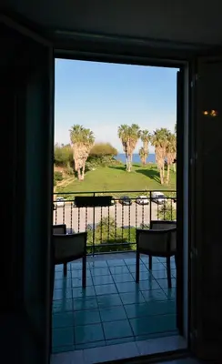 a sliding glass door with a view of a golf course at Hotel Villa d'Amato in Palermo