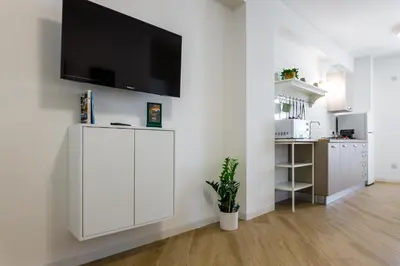 a living room with a white cabinet and a tv on a wall at TERRAVERA in Terrasini