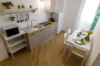 a small kitchen with a sink and a table at TERRAVERA in Terrasini