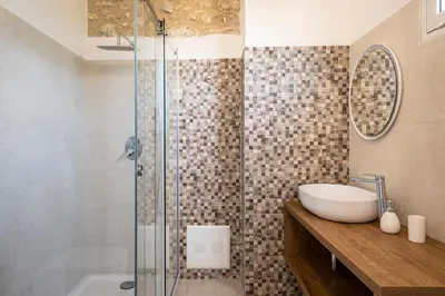a bathroom with a sink and a glass shower at Scialari Country House in Castellammare del Golfo