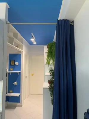 a blue ceiling in a room with a blue curtain at La Casetta Blu al Mulino in San Vito lo Capo