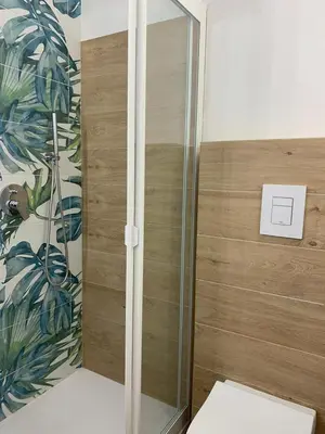 a shower with a glass door in a room at La Casetta Blu al Mulino in San Vito lo Capo