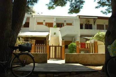 a bike parked in front of a house at La Casetta Blu al Mulino in San Vito lo Capo