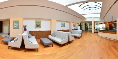 a waiting room with couches and chairs in a hospital at Splendid Hotel La Torre in Mondello