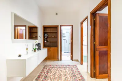 a hallway with a door and a rug at GuestHost - Teatro Politeama and Teatro Massimo Cozy Apartment in Palermo