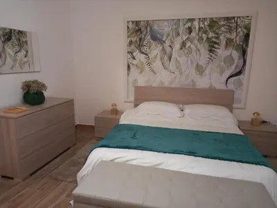 a bedroom with a bed and a painting on the wall at Casa dei Tre Re in Palermo