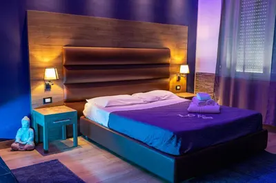 a bedroom with a bed with a wooden head board at Exclusive in Palermo