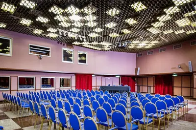 a room with blue chairs and a table in it at Astoria Palace Hotel in Palermo