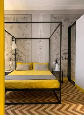 a bedroom with a canopy bed with yellow sheets at The347, Diletta in Palermo
