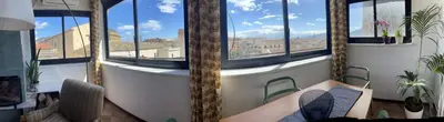 a room with large windows with a couch and chairs at Loft Aragonese in Palermo