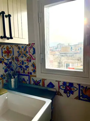 a bathroom with a window and a white sink at Loft Aragonese in Palermo
