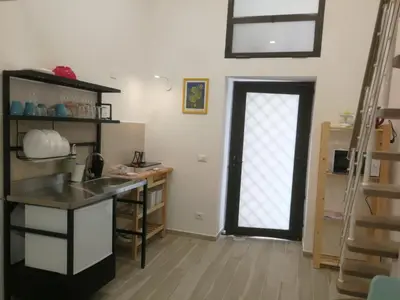 a kitchen with a sink and a door with a window at atocà2 confortevole loft- vedi anche atocà1 in Palermo