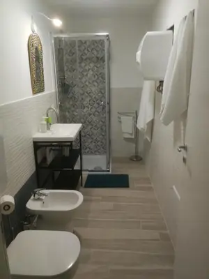a bathroom with a toilet and a sink and a shower at atocà2 confortevole loft- vedi anche atocà1 in Palermo