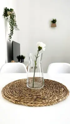 a vase with a flower in it on a table at La Casetta sul Golfo in Sferracavallo