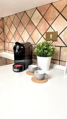 a coffee maker and two cups on a counter at La Casetta sul Golfo in Sferracavallo