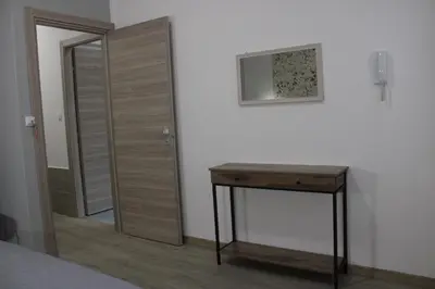 a room with a bed and a table and chairs at Terrazza Solemar -four rooms in Castellammare del Golfo