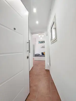 a hallway with a door leading to a bedroom at Guest House Palermo Massimo 23 in Palermo