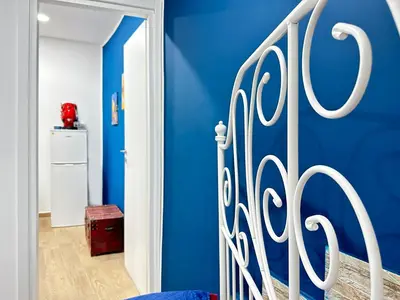 a blue bedroom with a blue wall and a gate at Palermo Centro - I Pastelli di Van Gogh in Palermo
