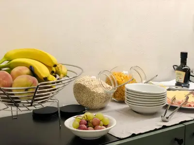 a counter with a bowl of fruit and a basket of food at B&B ALIVA in Alcamo