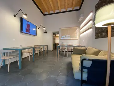 a dining room with a couch and a table and chairs at B&B ALIVA in Alcamo