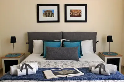 a bed with two lamps and two books on it at Antica Palermo in Palermo