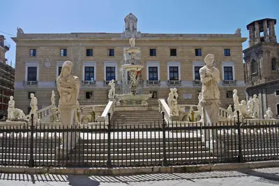 a fountain in front of a building with statues at Antica Palermo in Palermo