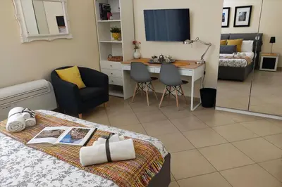 a bedroom with a bed and a desk and a table at Antica Palermo in Palermo