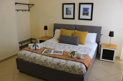 a bedroom with a large bed with two night stands at Antica Palermo in Palermo