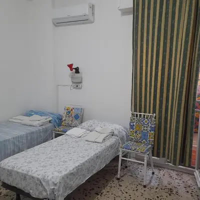 two beds and two chairs in a room at Desire'- Le Caprice in Palermo