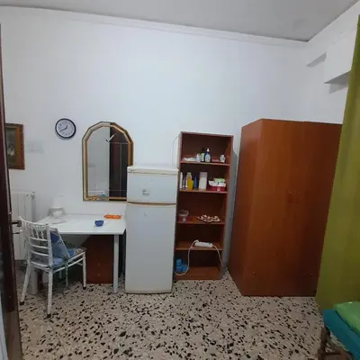 a kitchen with a desk and a refrigerator and a table at Desire'- Le Caprice in Palermo