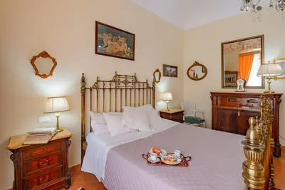 a bedroom with a bed with a tray of food on it at La casa di Dante in Palermo